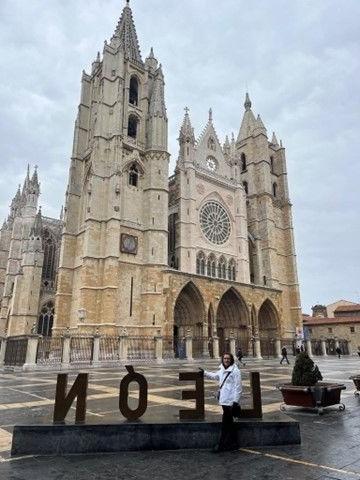 A large Spanish church with an art installation that says "LEON" in front of it