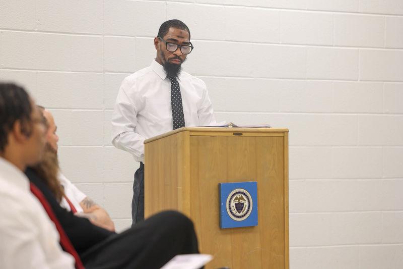 James speaking at a podium